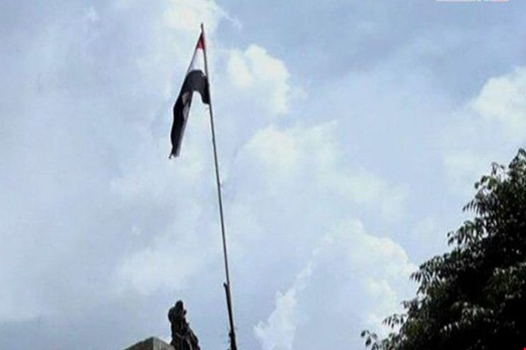 العلم السوري يرتفع فوق مبنى المحكمة في مخيّم اليرموك العلم السوري يرتفع فوق مبنى المحكمة في مخيّم اليرموك